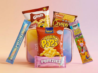 Assorted snack packages including corn puffs, chips, and candy on a pink background