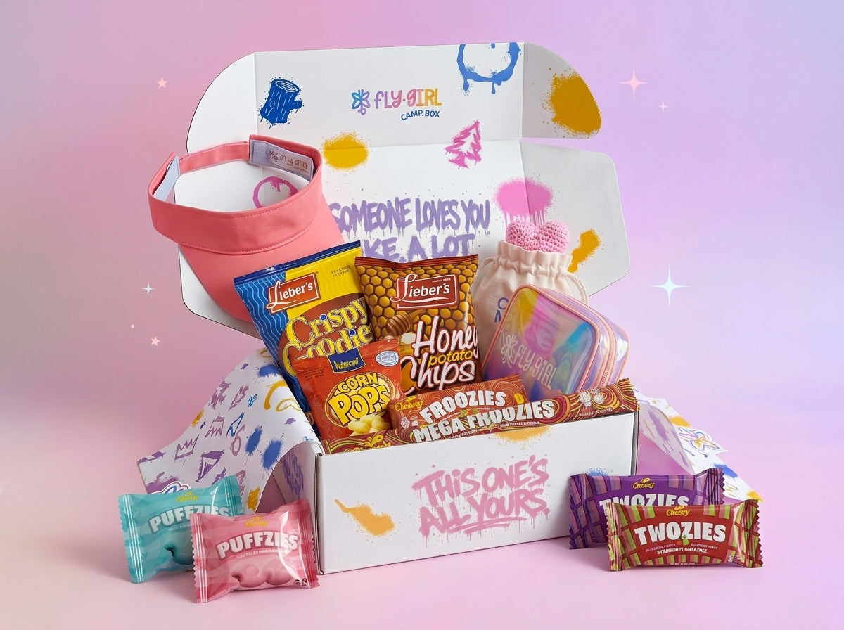 Colorful candy box with snacks and a visor on a pink background