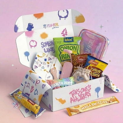Open box with various snacks and stationery items on a pink background