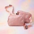 Pink crossbody bag with 'FLY GIRL' branding on a gradient background