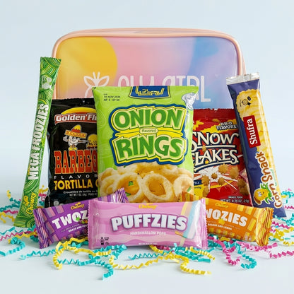 Assorted snack packages including Onion Rings, Puffzies, and other treats on a colorful background.